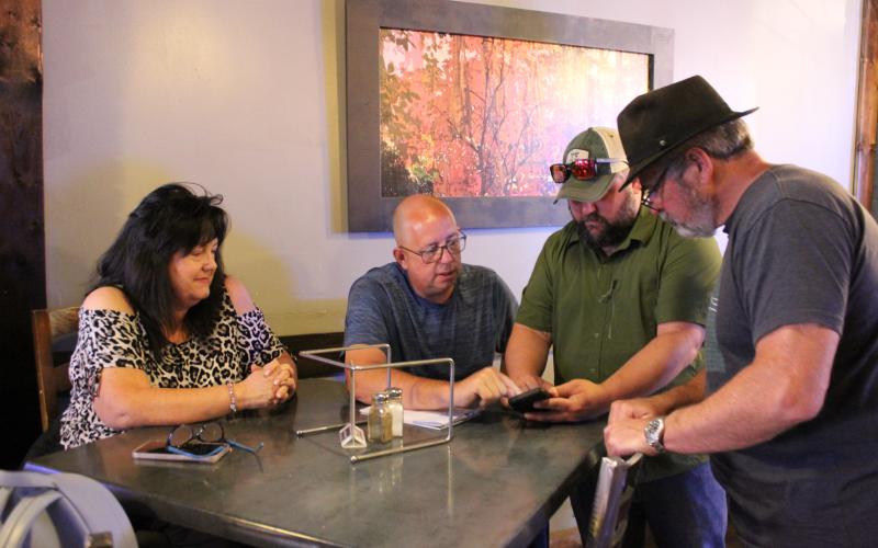 Paula and Jeff Fuller (from left), owners of Pursenality and Boxcar Café and Cones, attended a small town meeting with engineer Nate Bowe and Mayor Tom Sutton on Tuesday, Aug. 1 to talk about the utilities work going on.