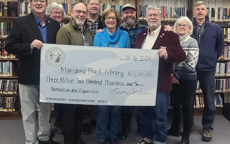 Jeff Delfield, Swain County librarian and Ellen Snodgrass, Marianna Black Library Board chair (center) accept a $3.2 million from Senator Kevin Corbin (left) and Rep. Mike Clampitt. Pictured back row from left are MBL Board members Cynthia Womble, Christian Siewers, Swain County Commissioner Kevin Seagle, and MBL board members Mary Danals and Anthony Monnat.