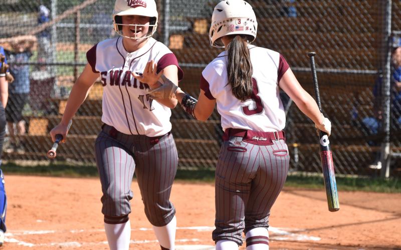 Lady Devils Maddie Bird and Makenzee Bird share a celebratory high-five during the win against Hiwassee Dam last week. 